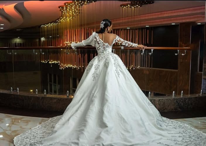 Ball gown with a dramatic cathedral train at night — Gia Bridals, Port Harcourt